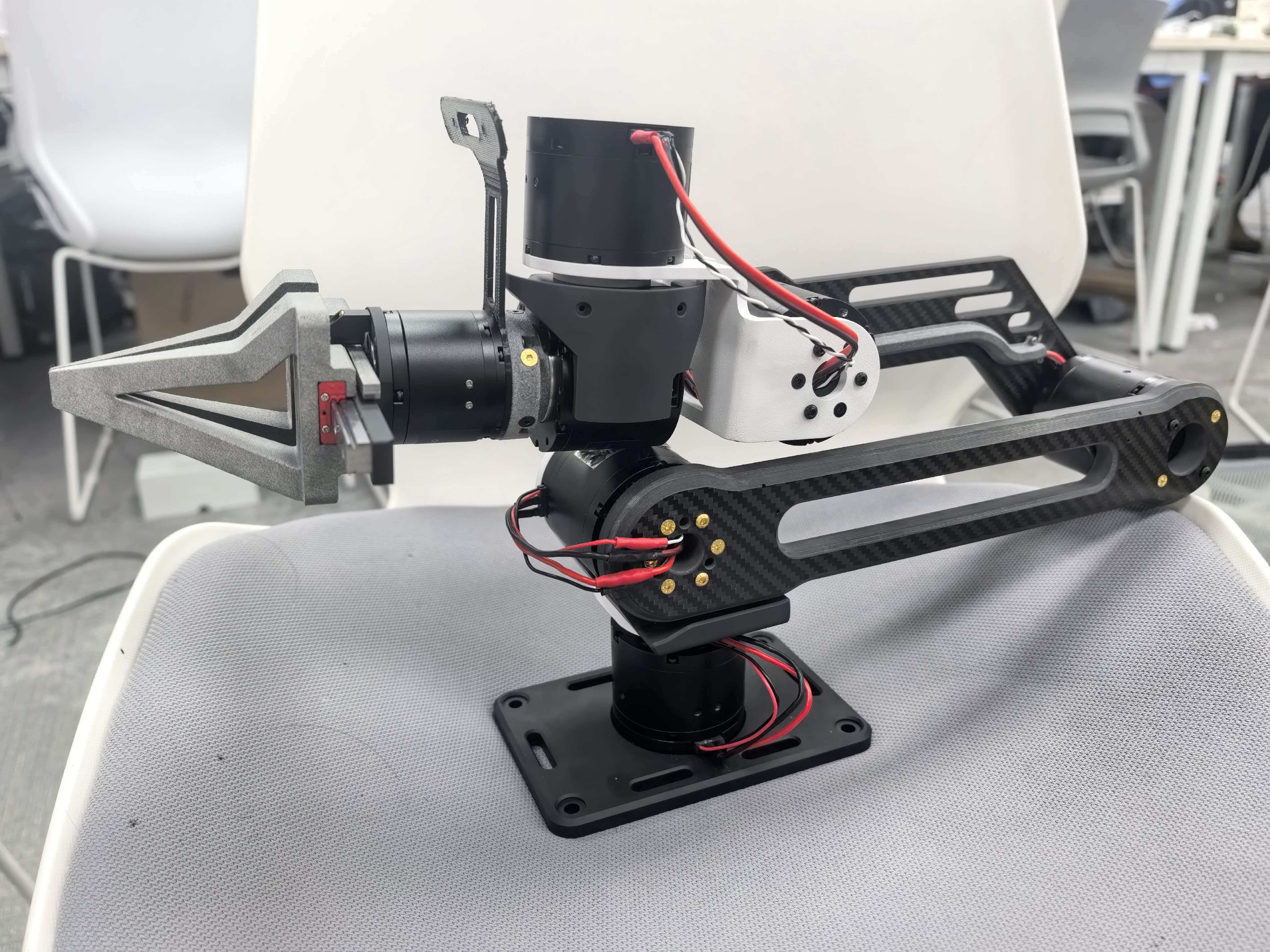 Iteration 3 arm built from CNC-machined parts and carbon fiber layup